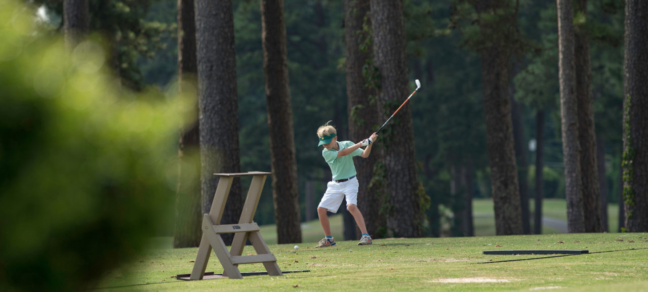 Young golfer on Forest Hills practice driving range